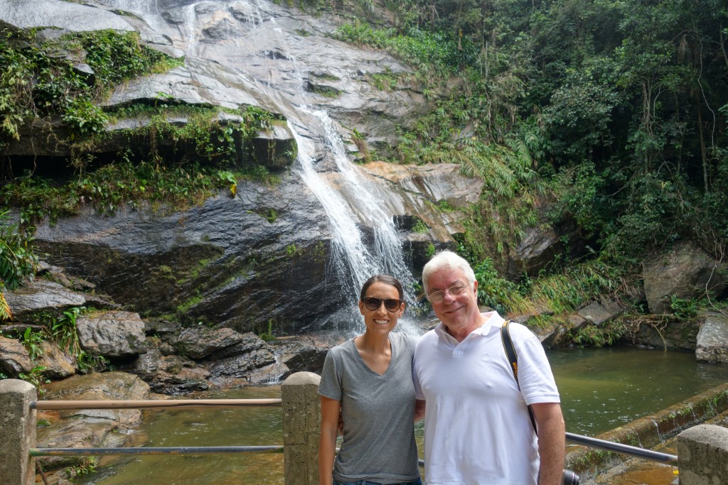 Katie and Celso in front of a waterfall at Tijuca National Park