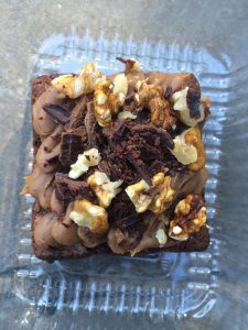 Brownie topped with dulce de leche and nuts